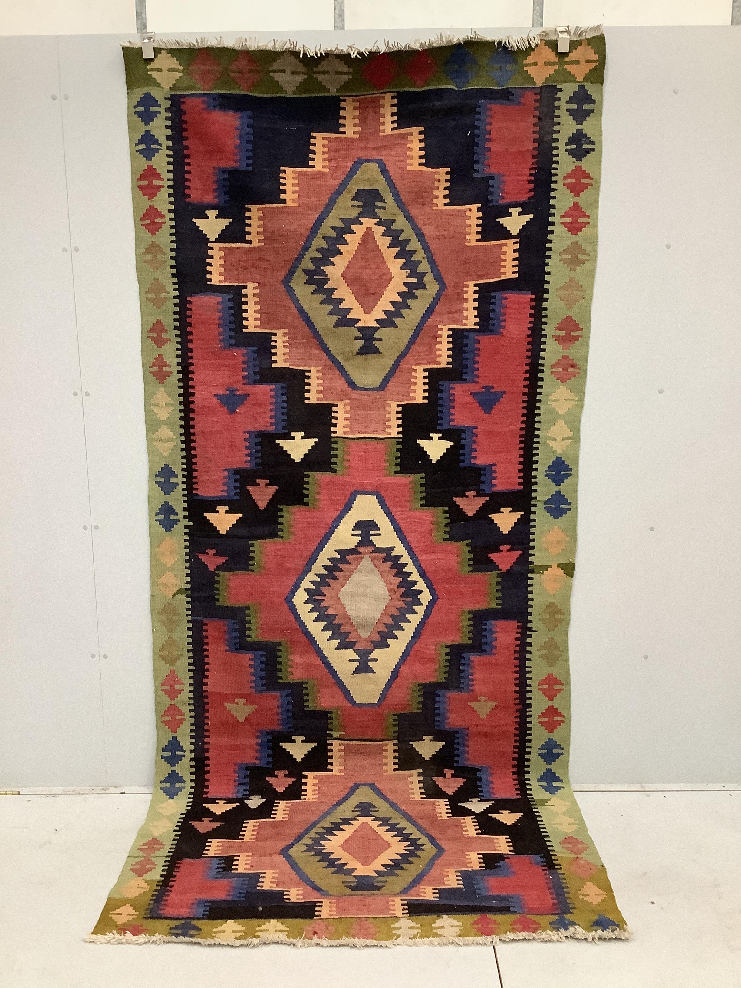 A Kilim geometric polychrome rug, approximately 320 x 140cm